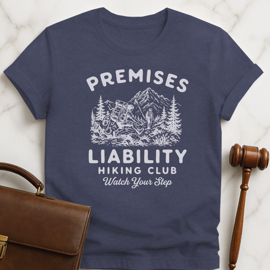 cool law school graduate graphic t shirt that says premises liability hiking club watch your step featuring a hiker falling in heather blue