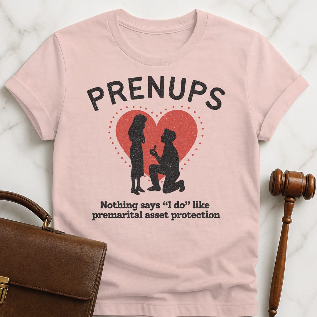 funny law graduate tshirt that says Prenups Nothing Says I Do Like Premarital Asset Protection featuring Man proposing to woman with a heart in pink