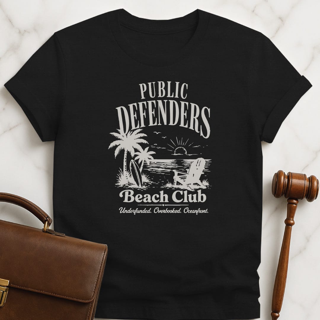 cool new attorney graphic t shirt that says Public defenders beach club underfunded overbooked oceanfront featuring beach with palm trees and beach chairs in black