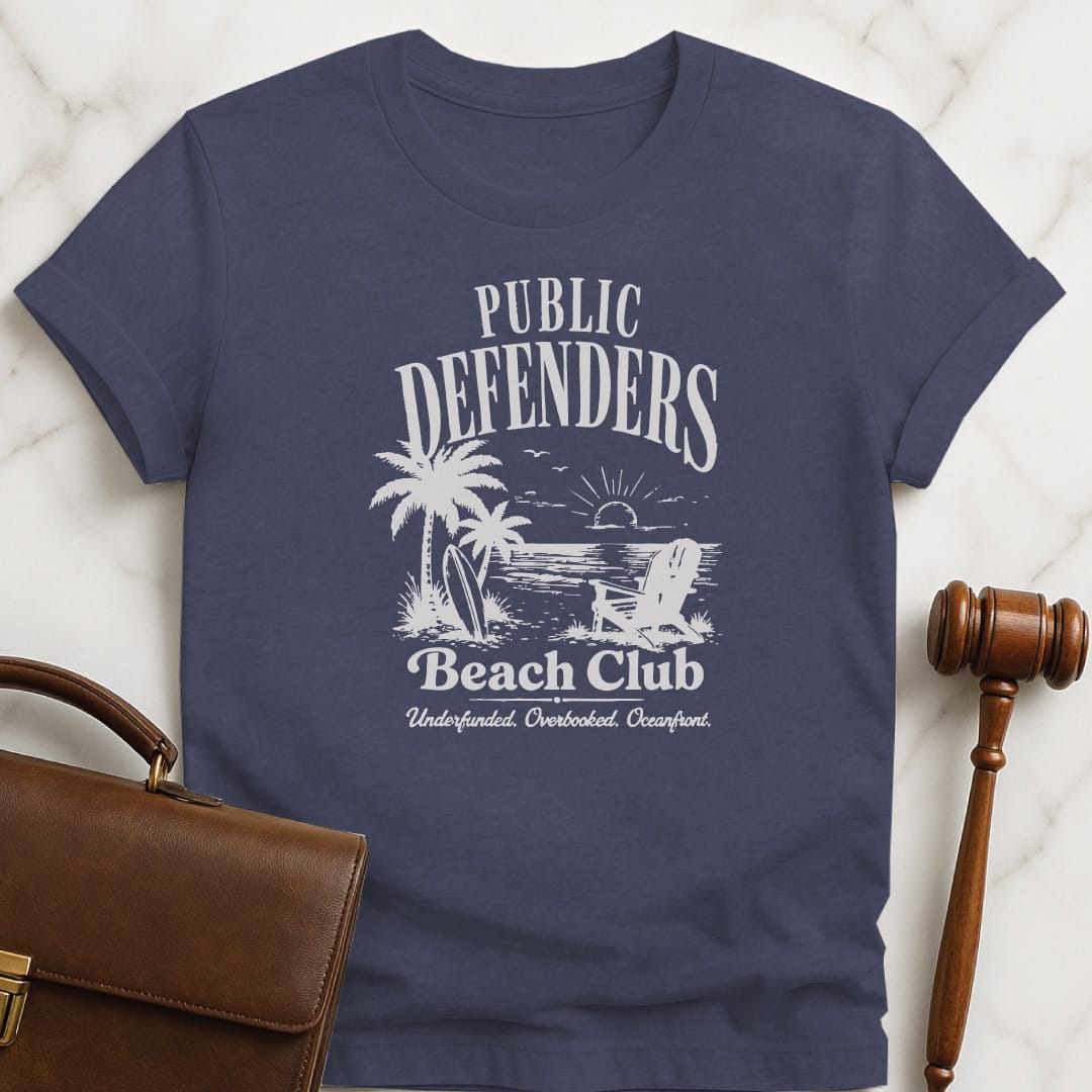 cool attorney graphic tee that says Public defenders beach club underfunded overbooked oceanfront featuring beach with palm trees and beach chairs in heather blue