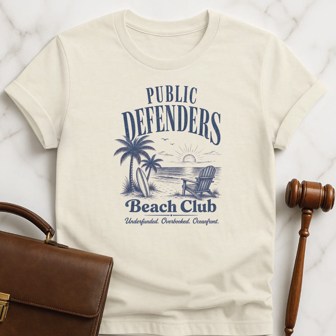 funny law school t-shirt that says Public defenders beach club underfunded overbooked oceanfront featuring beach with palm trees and beach chairs in cream