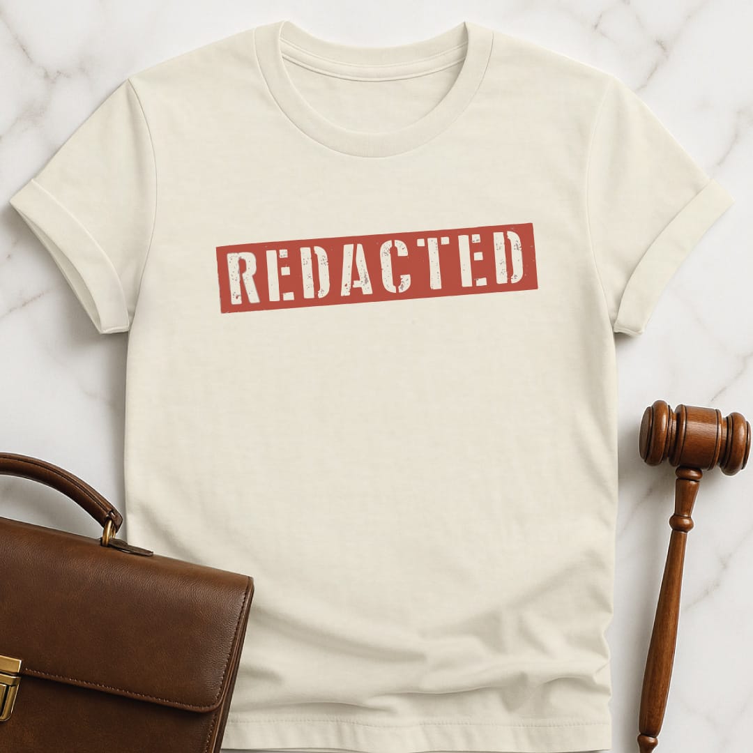 trendy law school graduate t-shirt that says Redacted featuring red letters in cream