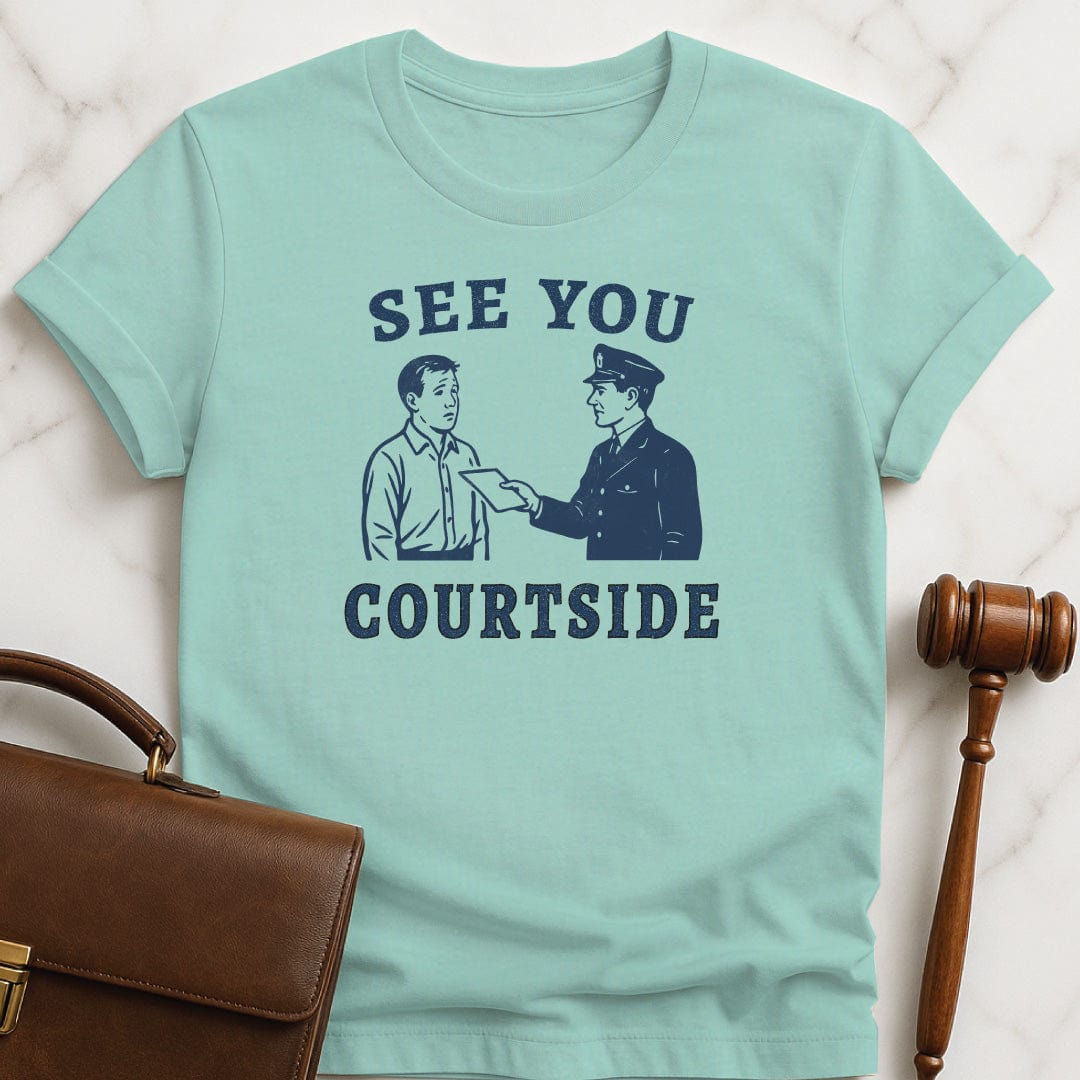 retro law student t-shirt that says See You Courtside featuring police officer handing a person a piece of paper in heather green