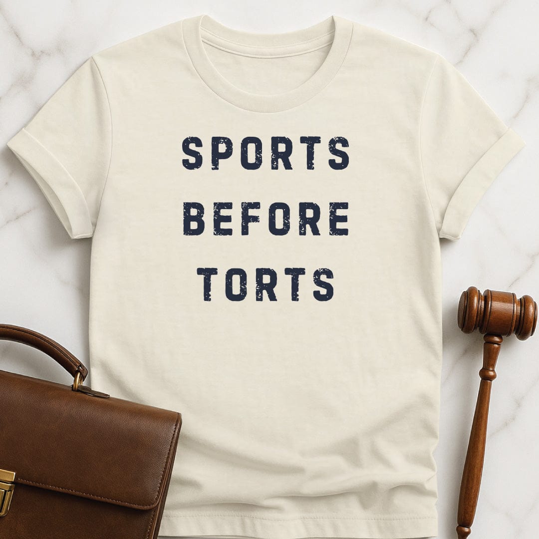 funny new attorney graphic tshirt that says Sports Before Torts in cream