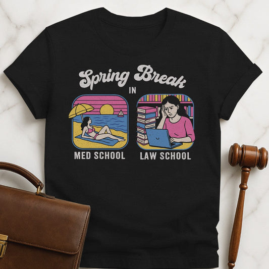 funny law graduate t-shirt that says Spring break in med school and law school featuring med school student is on the beach and law school student is in the library in black
