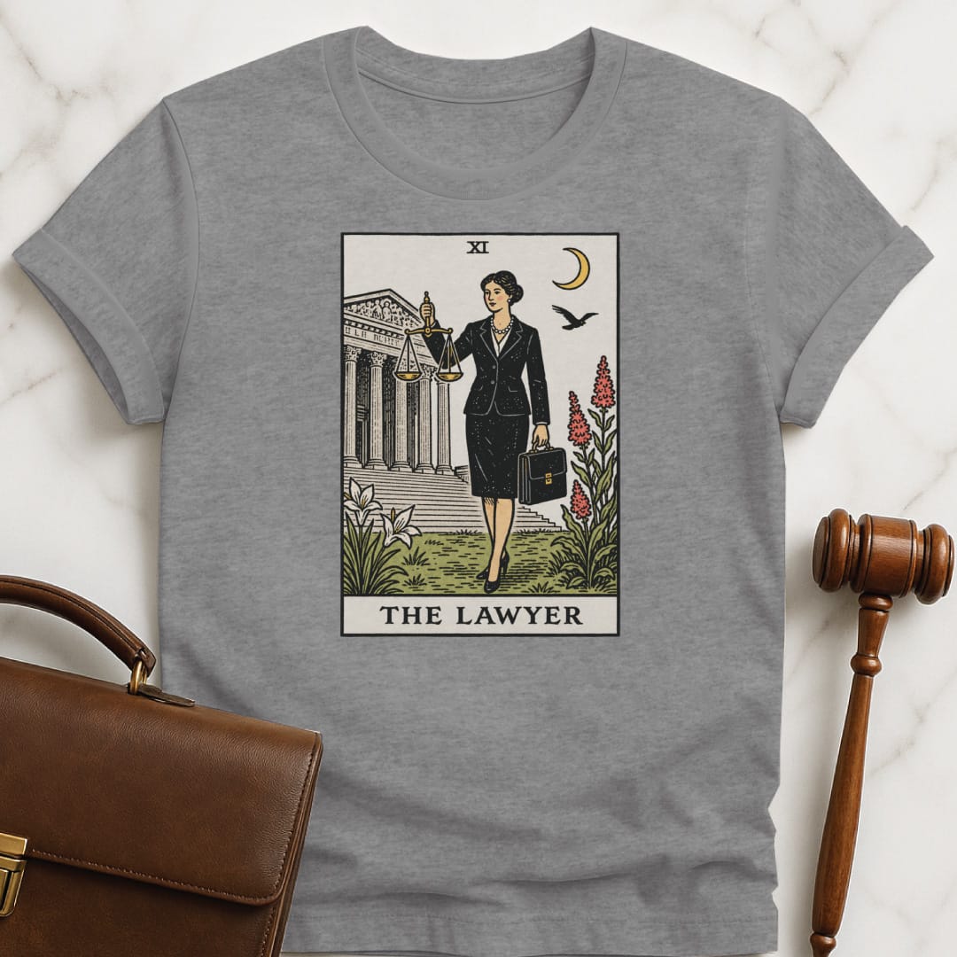 unique law school grad t shirt that says The Lawyer featuring tarot card style of a woman lawyer holding a scales of justice in front of a courthouse in grey