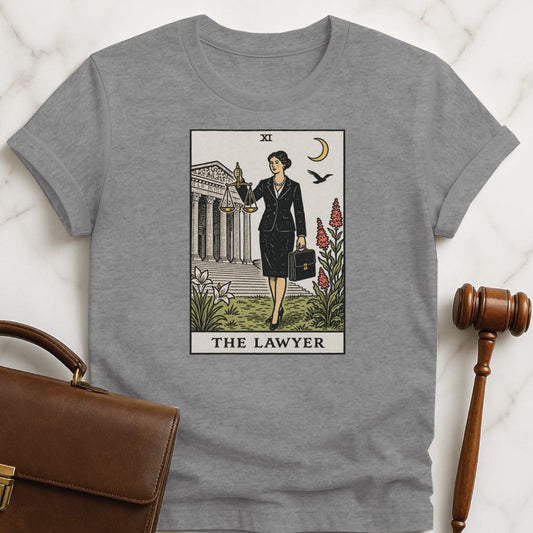unique law school grad t shirt that says The Lawyer featuring tarot card style of a woman lawyer holding a scales of justice in front of a courthouse in grey