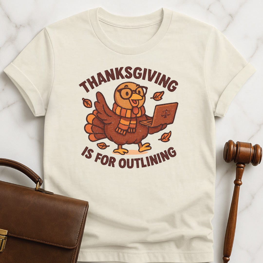 cute law school graphic tee that says thanksgiving is for outlining featuring a turkey in a scarf and glasses holding a laptop in cream