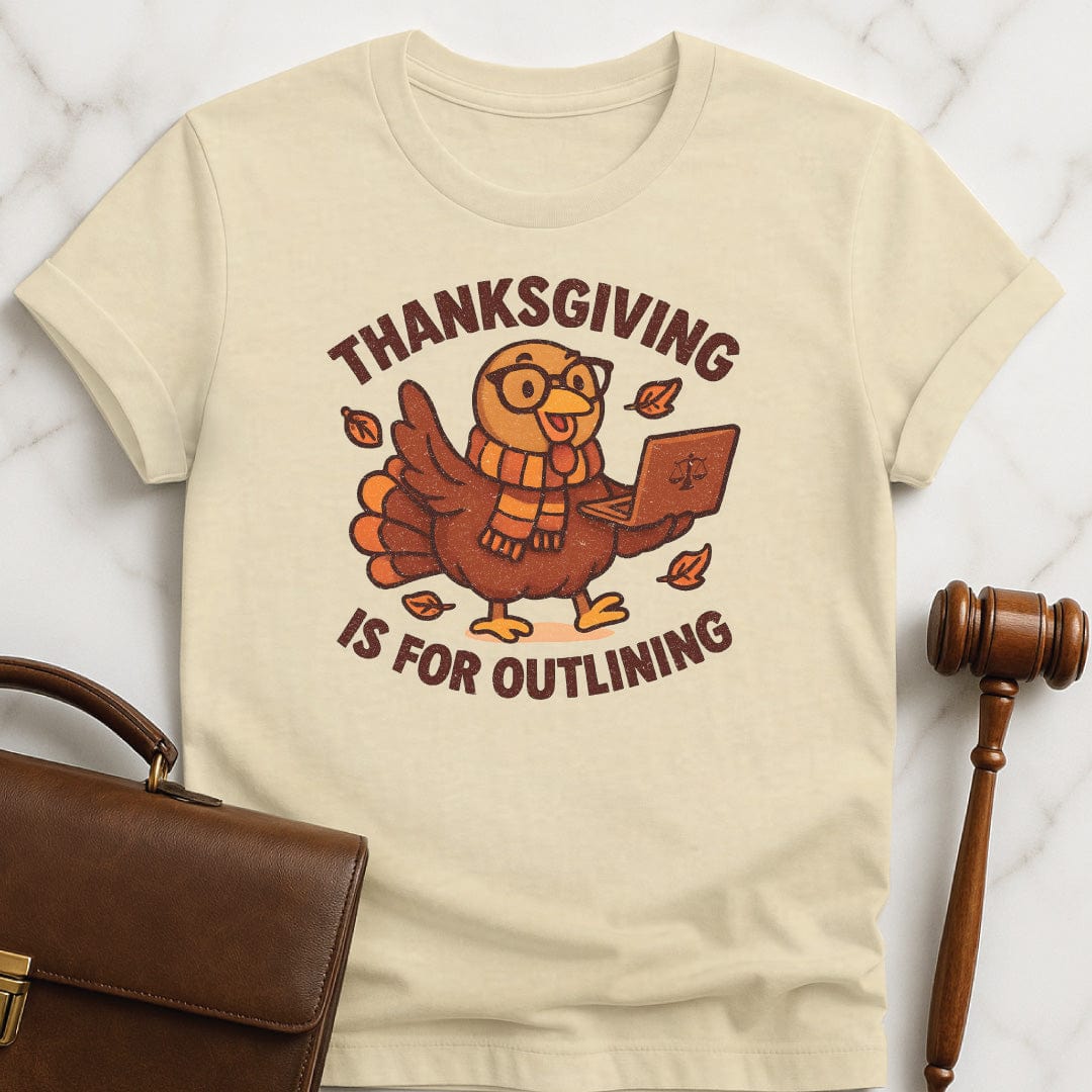 funny law student t-shirt that says thanksgiving is for outlining featuring a turkey in a scarf and glasses holding a laptop in cream