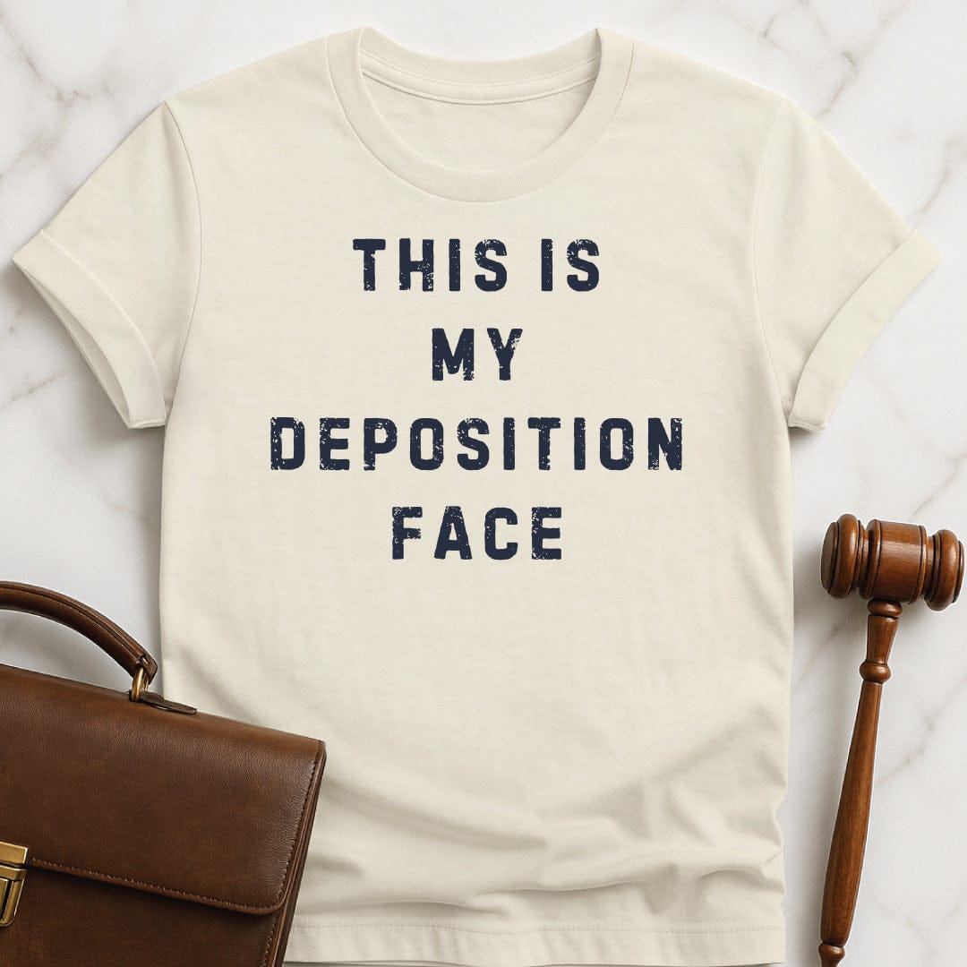 funny attorney graphic t-shirt that says this is my deposition face in cream