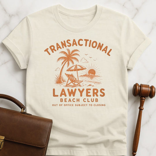 funny attorney t-shirt that says transactional lawyers beach club out of office subject to closing featuring beach scene in cream