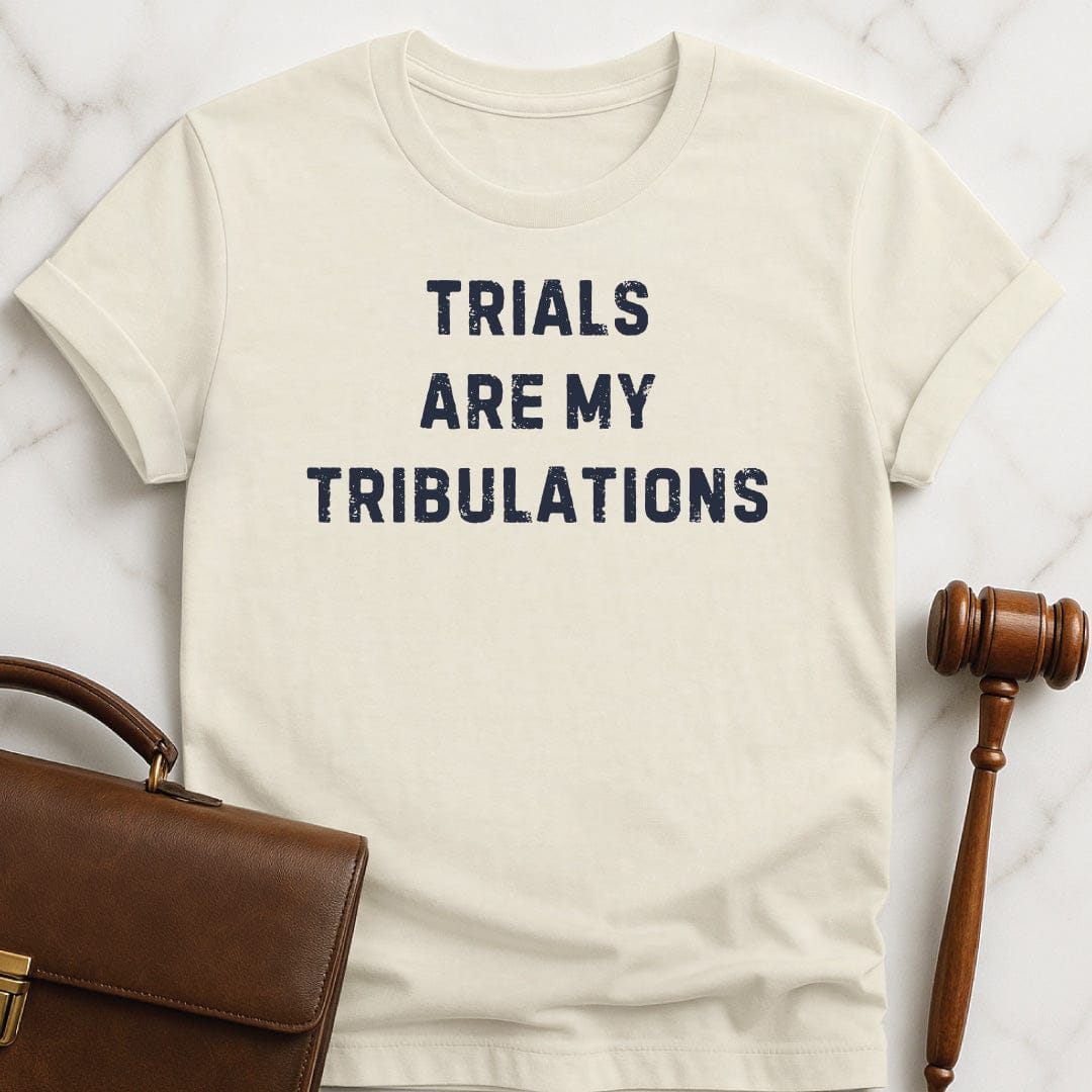 funny law graduate t-shirt that says trials are my tribulations in cream