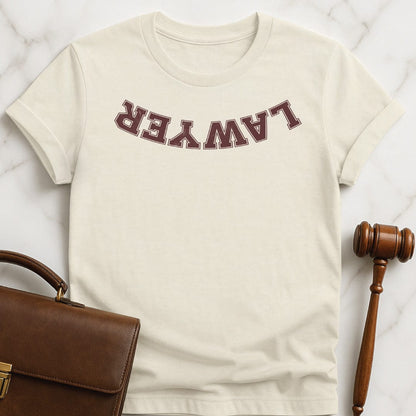 cool law school graduate graphic tshirt that says Lawyer upside down in cream