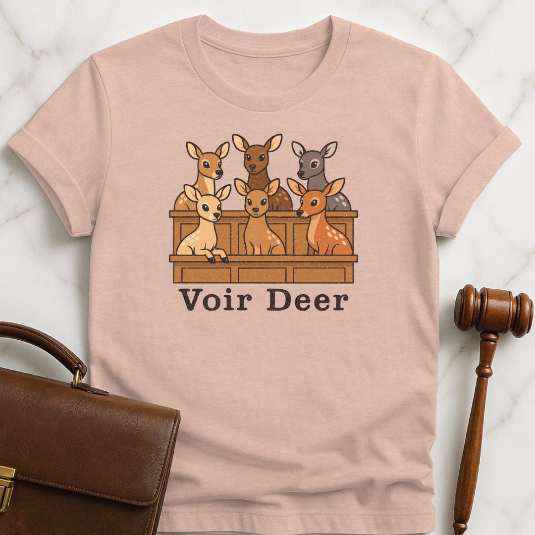 funny attorney graphic t-shirt that says Voir Deer featuring deer in a jury box in heather peach