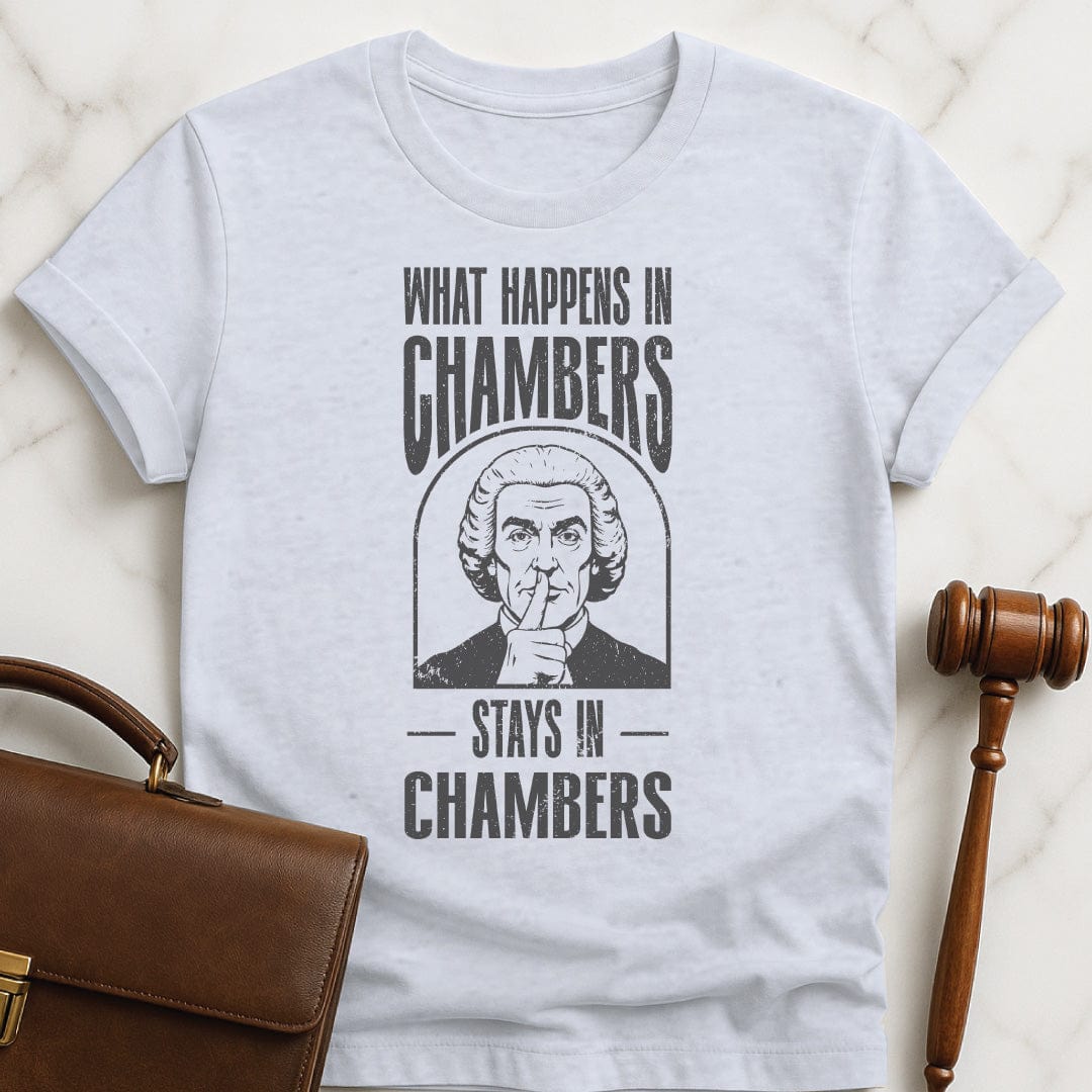 funny law graduate graphic t-shirt that says what happens in chambers stays in chambers featuring a judge with his fingers to his lips in grey