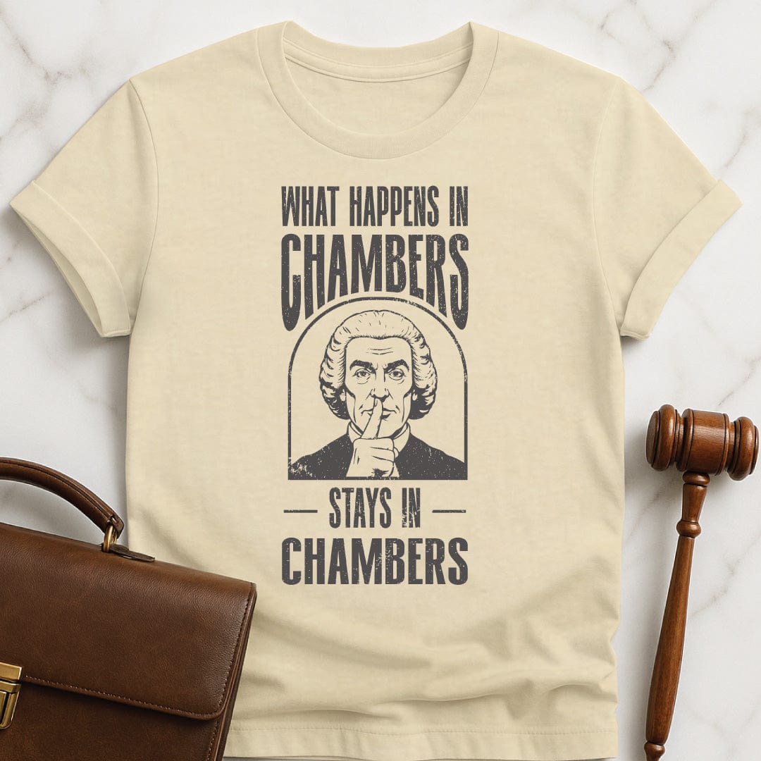 cool lawyer graphic tee that says what happens in chambers stays in chambers featuring a judge with his fingers to his lips in cream