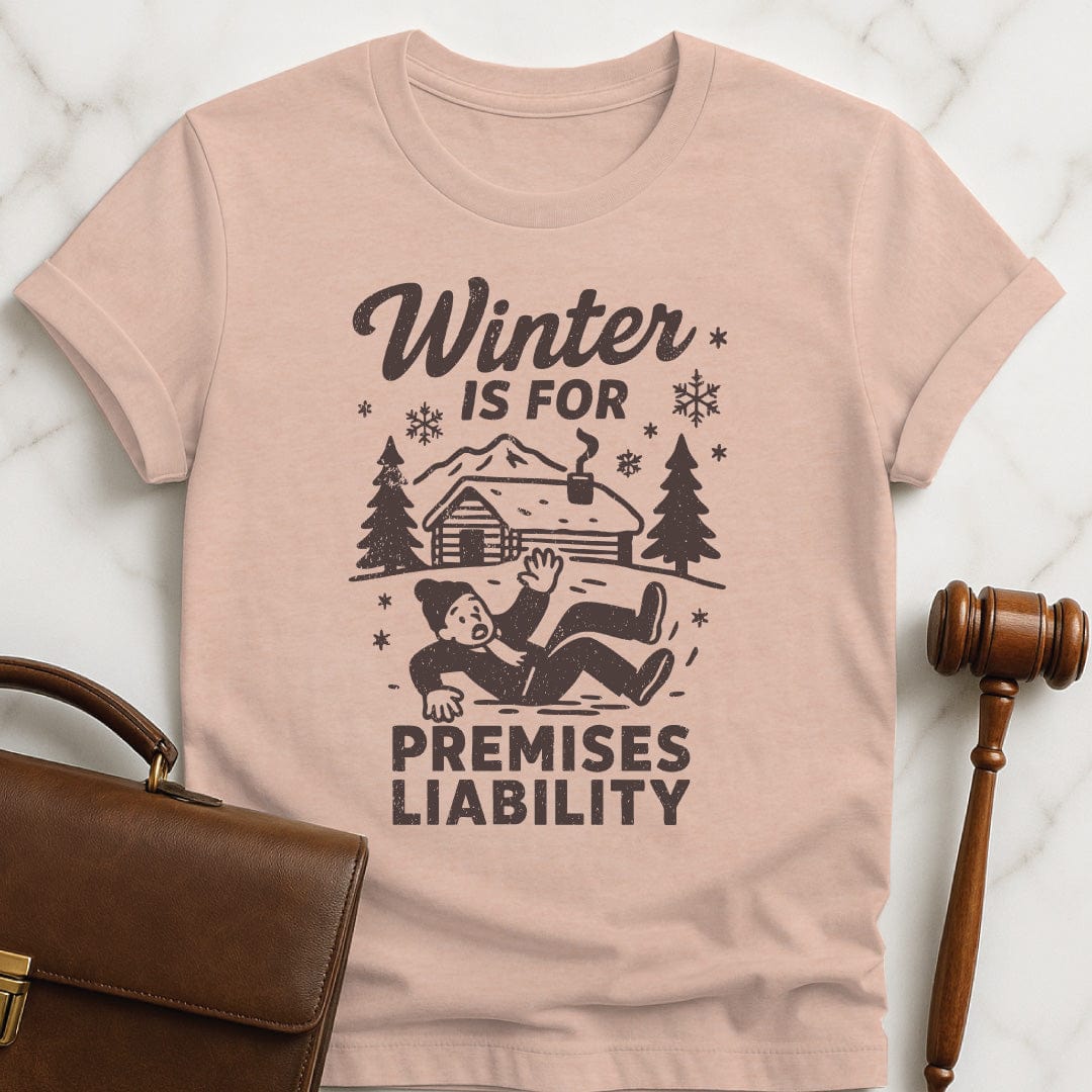 funny attorney graphic t-shirt that says Winter is for premises liability featuring man falling on snow in heather peach