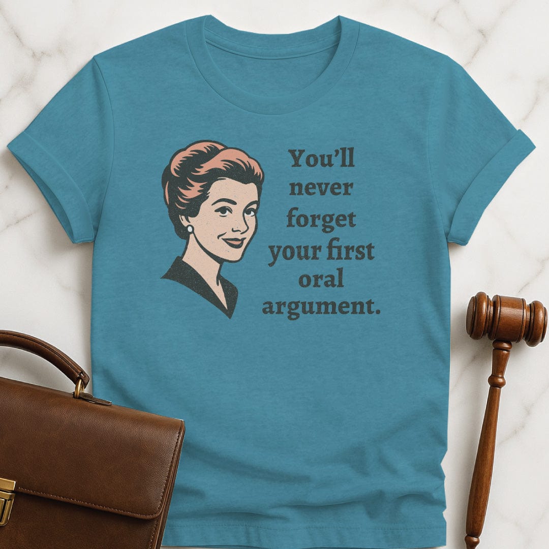retro lawyer graphic tee that says You Never Forget Your First Oral Argument featuring A retro woman in heather aqua